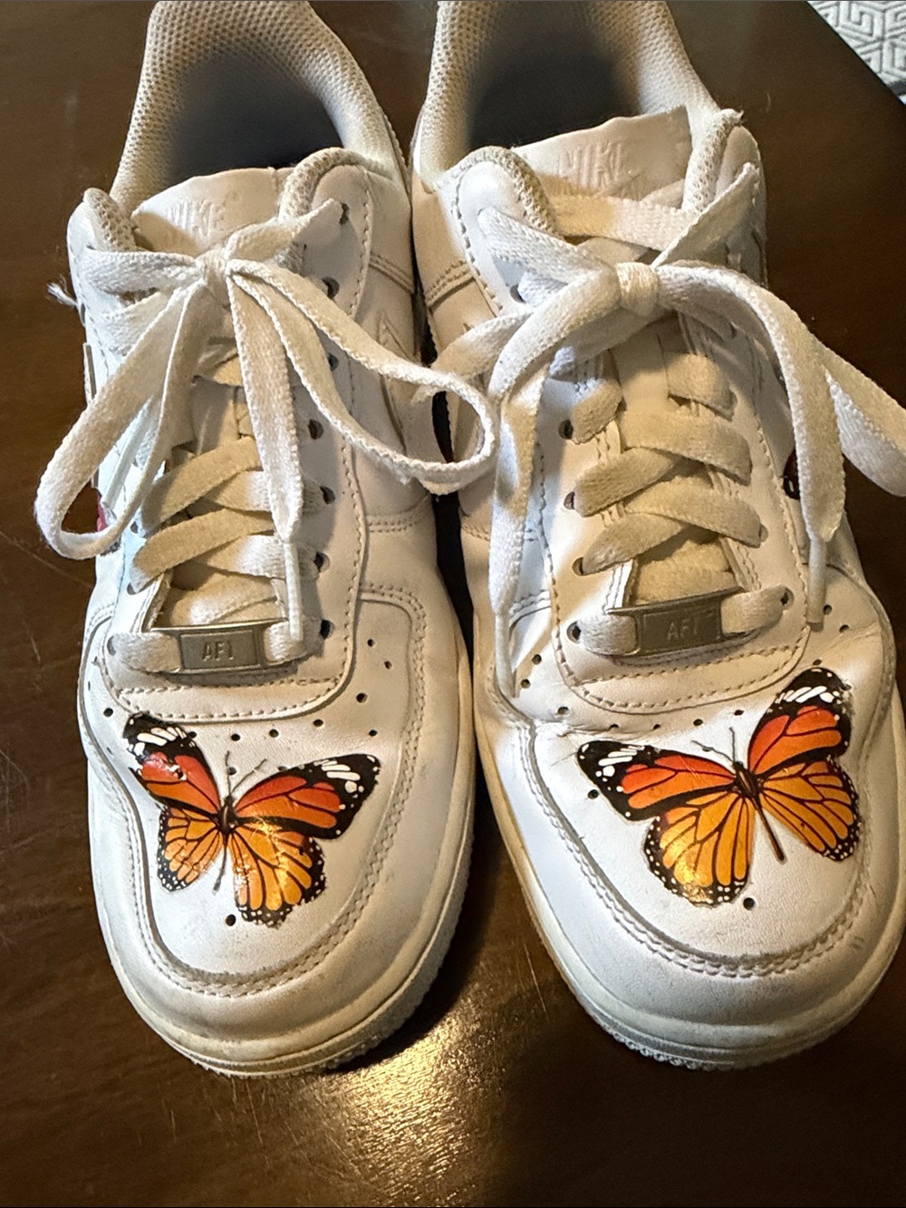 Nike White Sneakers with Orange Butterfly Motif